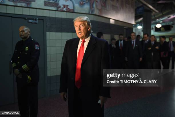 President-elect Donald Trump talks with media, after his meeting with families and victims of last week's attack at Ohio State University, December...