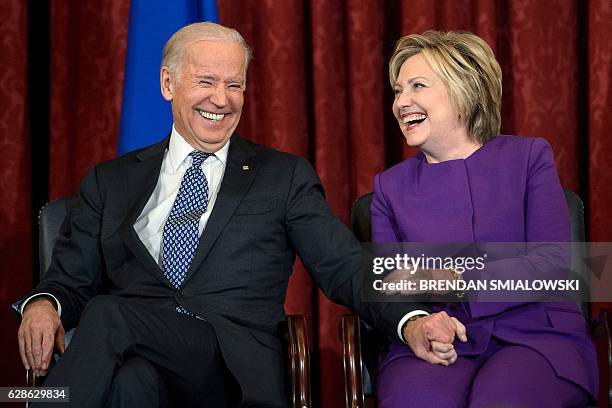 Vice President Joe R. Biden and former Secretary of State Hillary Clinton laugh during a portrait unveiling for outgoing Senate Minority Leader...