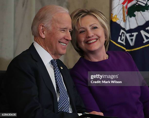 Former US Secretary of State, Hillary Clinton shares a laugh with US Vice President Joseph Biden, during a portrait unveiling ceremony for outgoing...