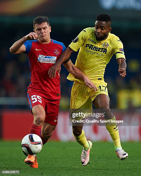 Alexandru Bourceanu of Steaua Bucuresti competes for the ball with Cedric Bakambu of Villarreal during the UEFA Europa League match group L between...