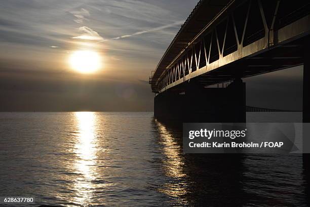 oresundsbron bridge at sunset - oresund bridge stock pictures, royalty-free photos & images