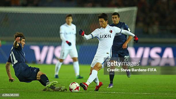 Diago Nishi of Kashima Antlers is tackled by Fabrizio Tavano of Auckland City during the FIFA Club World Cup Play-off for Quarter Final match between...