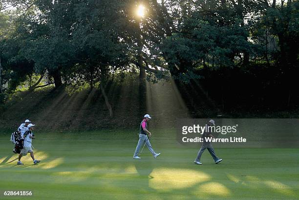 Brett Rumford of Australia and Adilson Da Silva of Brazil walk up the second fairway during the second round of the USB Hong Kong Open at The Hong...