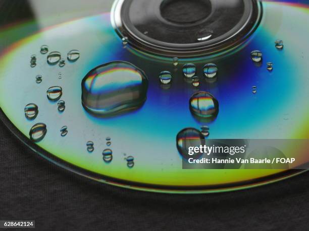 waterdrop on musical cd - hannie van baarle stock pictures, royalty-free photos & images