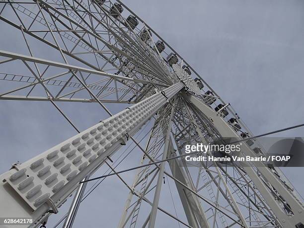 low angle view of ferris wheel - hannie van baarle stock pictures, royalty-free photos & images