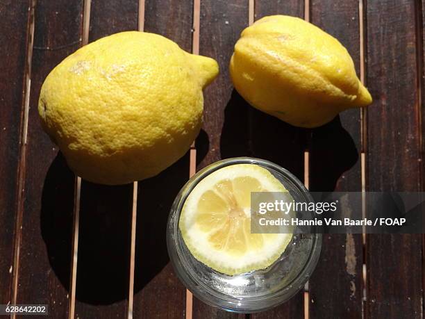 close-up of lemons on wooden - hannie van baarle stock pictures, royalty-free photos & images