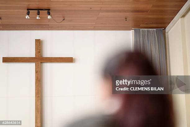Afghan refugee Faridah visits a course preparing her to convert into christian confession by baptism in Berlin, on October 23, 2016. / AFP / CLEMENS...