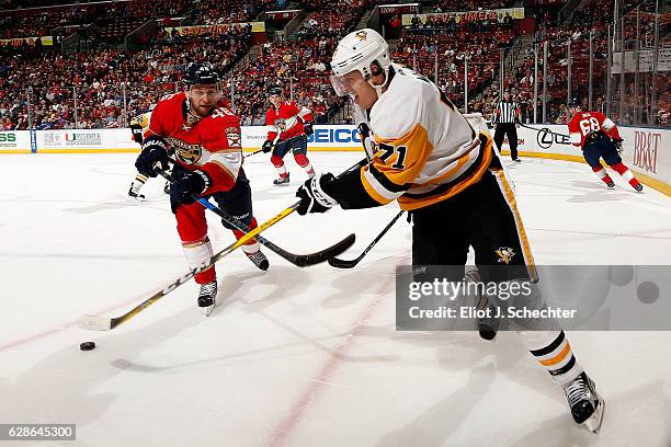 Evgeni Malkin of the Pittsburgh Penguins skates with the puck against Jakub Kindl of the Florida Panthers at the BB&T Center on December 8, 2016 in...