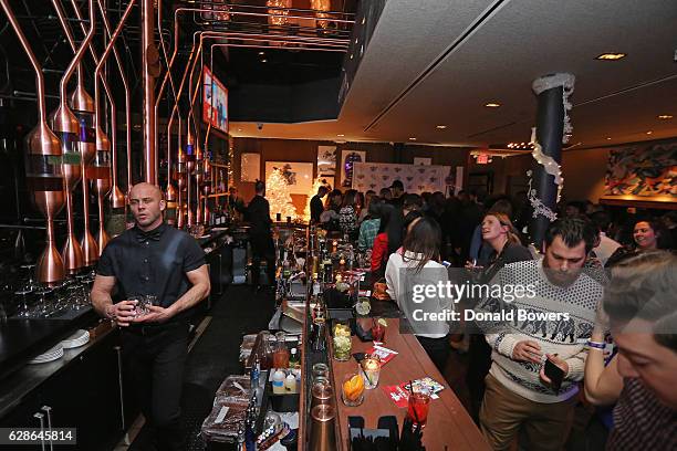 Bartenders prepare drinks during the Musicians On Call Deck The Halls Holiday Sweater Party at Kola House on December 8, 2016 in New York City.