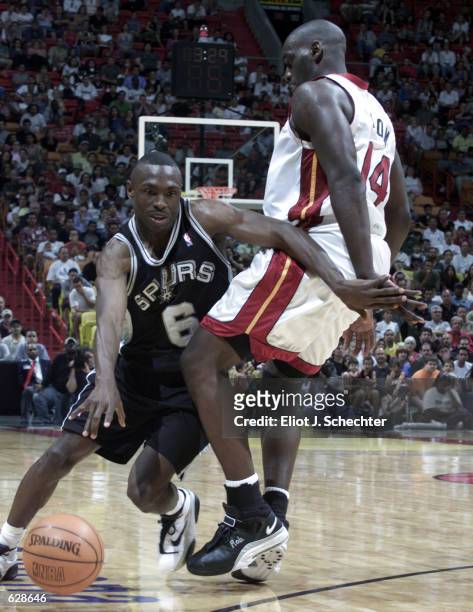 Avery Johnson of the San Antonio Spurs goes around Anthony Mason of the Miami Heat in the fourth period at the American Airlines Arena in Miami,...
