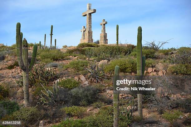 Three stone crosses and cacti on top of hillside overlooking Sea of Cortez on the Baja California Peninsula near La Paz Mexico