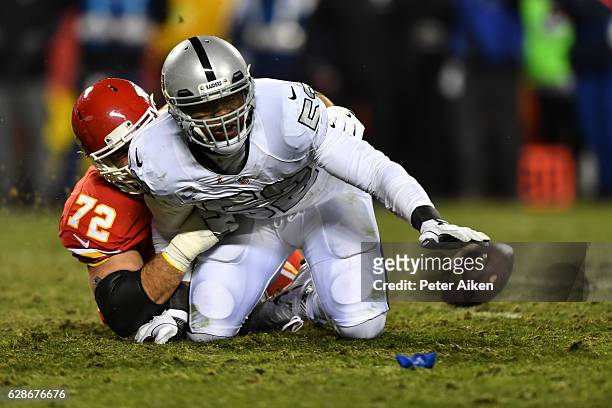 Tackle Eric Fisher of the Kansas City Chiefs stops defensive end Khalil Mack of the Oakland Raiders from recovering a caused fumble at Arrowhead...