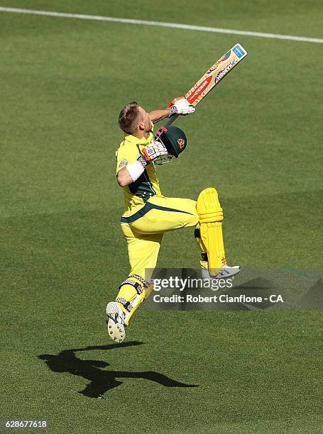 David Warner of Australia celebrates after reaching his century during game three of the One Day International series between Australia and New...