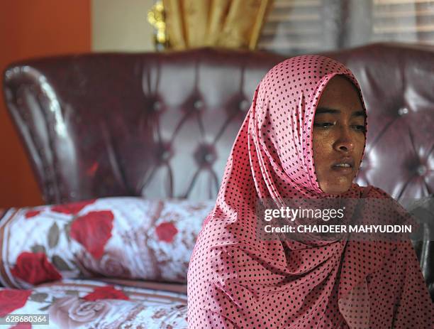 In this photograph taken on December 8 Yusra Fitriani mourns in a room which was supposed to be her bridal bedroom in Pidie Jaya, Aceh province. On...