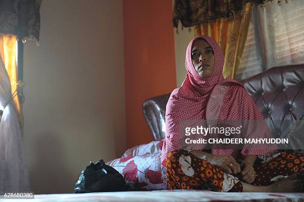 In this photograph taken on December 8 Yusra Fitriani mourns in a room which was supposed to be her bridal bedroom in Pidie Jaya, Aceh province. On...