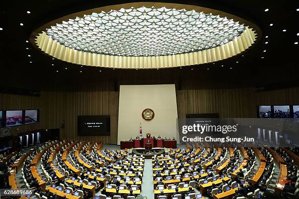 Lawmakers attend a plenary session to vote on the impeachment bill of President Park Geun-hye at the National Assembly on December 9, 2016 in Seoul,...