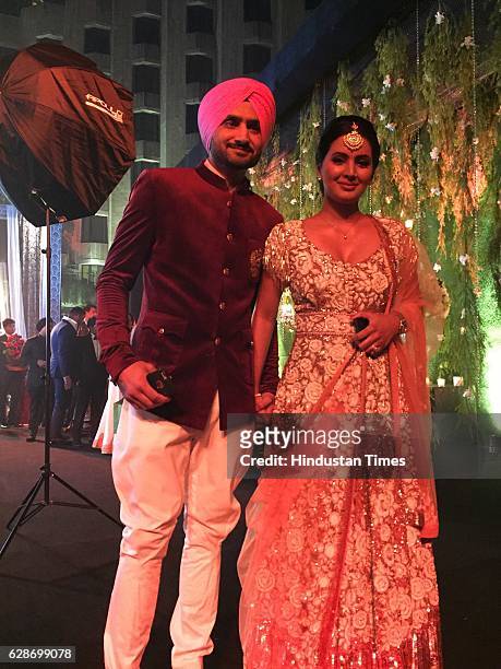 Cricketer Harbhajan Singh with his wife and actor Geeta Basra during the wedding reception of Indian Cricketer Yuvraj Singh and Bollywood actor Hazel...