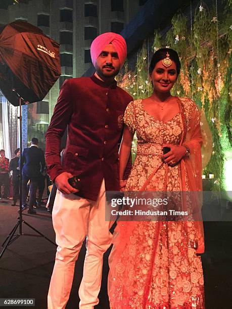 Cricketer Harbhajan Singh with his wife and actor Geeta Basra during the wedding reception of Indian Cricketer Yuvraj Singh and Bollywood actor Hazel...