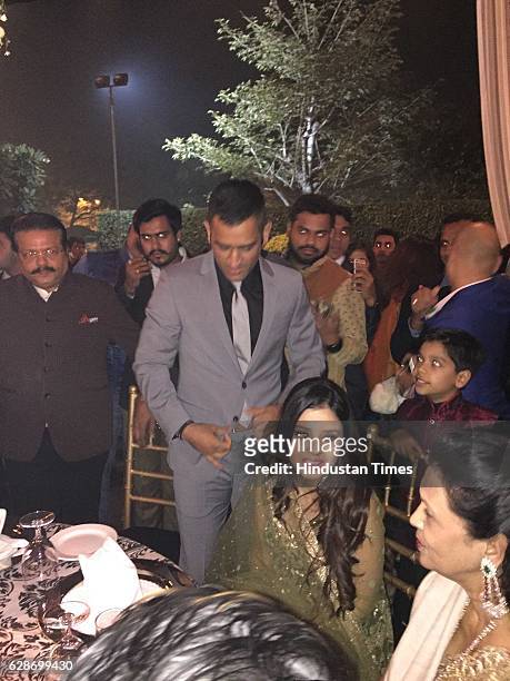 Cricketer MS Dhoni with his wife Sakshi Dhoni during the wedding reception of Indian Cricketer Yuvraj Singh and Bollywood actor Hazel Keech, at ITC...