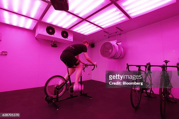 Cyclist rides a stationary bicycle to test out kit in 'The Vault', a climactic simulation chamber in the basement of the Rapha Racing Ltd. Cycle club...
