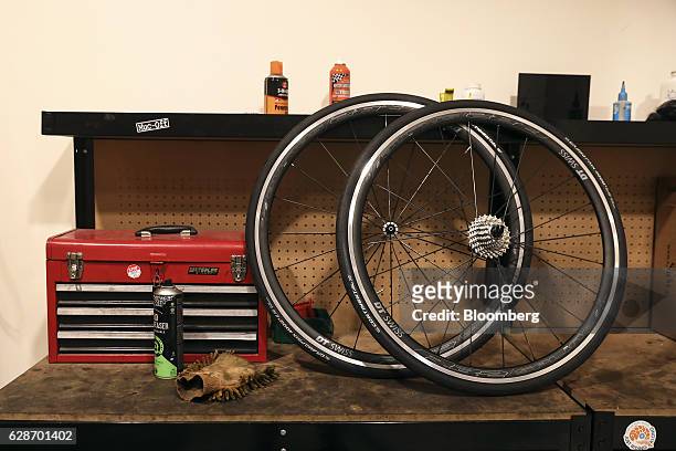 Pair of bicycle wheels sit in the workshop area at the Rapha Racing Ltd. Headquarters office in London, U.K., on Thursday, Nov. 10, 2016. To keep...