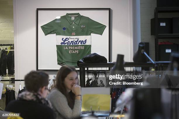 Vintage Rapha and Paul Smith collaborative jersey sits framed on the wall in the design area at the Rapha Racing Ltd. Headquarters office in London,...