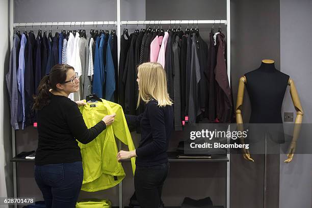 Employees discuss the fabrics of the new city riding range in a meeting room at the Rapha Racing Ltd. Headquarters office in London, U.K., on...