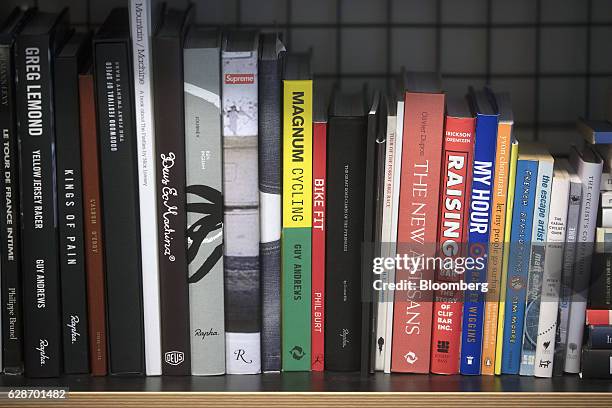Various cycling related books sit on a bookshelf at the Rapha Racing Ltd. Headquarters office in London, U.K., on Thursday, Nov. 10, 2016. To keep...