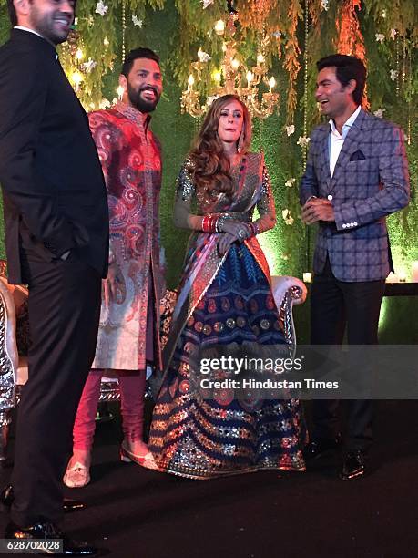 Indian Cricketer Yuvraj Singh with his wife and Bollywood actor Hazel Keech and Cricketer Mohammad Kaif during their wedding reception, at ITC...