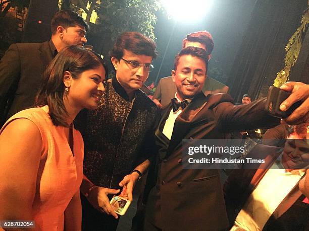 Former Indian cricketer Sourav Ganguly with cricketer Pragyan Ojha and his wife Karabi Baral during the wedding reception of Indian Cricketer Yuvraj...