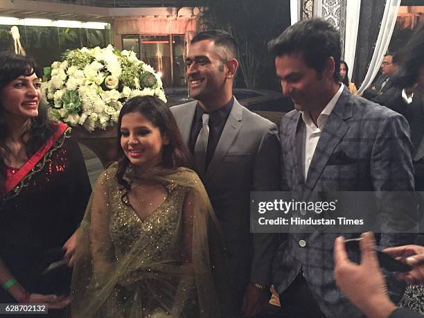 Indian cricketer MS Dhoni with his wife Sakshi Dhoni and cricketer Mohammad Kaif during the wedding reception of Indian Cricketer Yuvraj Singh and...