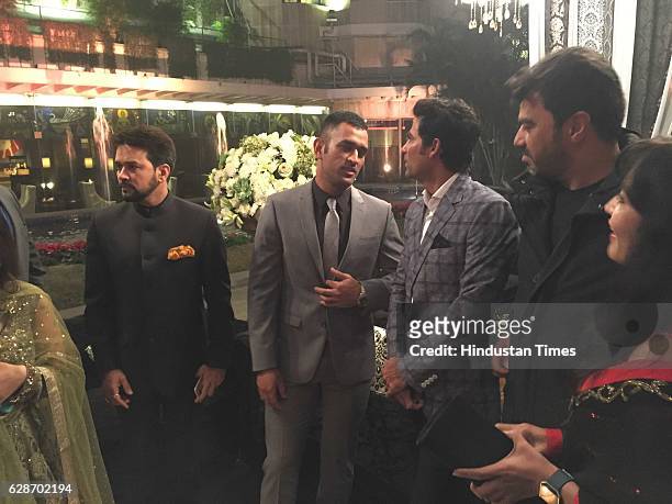 President Anurag Thakur with cricketers MS Dhoni and Mohammad Kaif during the wedding reception of Indian Cricketer Yuvraj Singh and Bollywood actor...