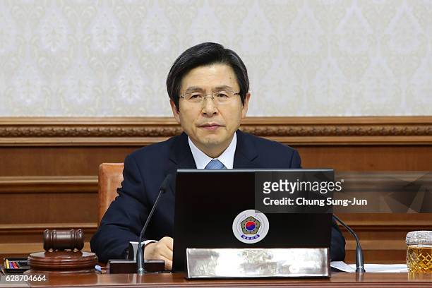 Acting President of South Korea Hwang Kyo-Ahn attends the cabinet meeting after parliament passed the impeachment motion against President Park...