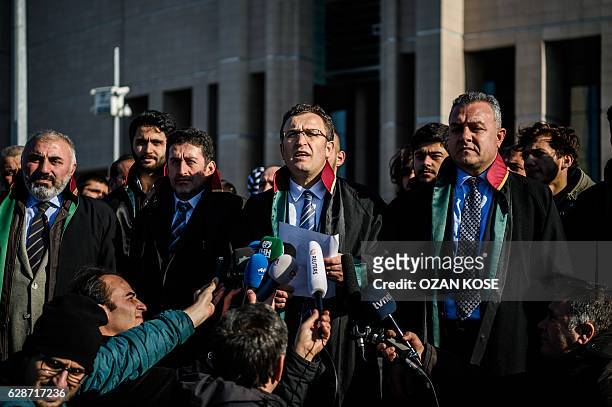 Lawers of victims speaks to the press before the trial opening on December 9, 2016 outside the Istanbul courthouse as Turkish court is expected to...