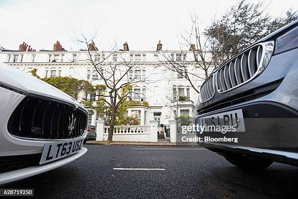 Luxury automobile manufactured by Maserati SpA, left and an automobile manufactured by Bayerische Motoren Werke AG , right, stand parked outside...