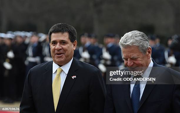 German President Joachim Gauck and his Paraguayan counterpart Horacio Cartes inspect a military honor guard at the presidential Bellevue Palace on...