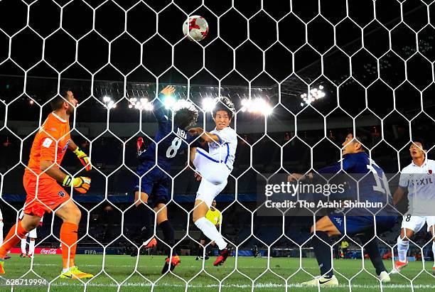 Mu Kanazaki of Kashima Antlers heads to score his team's second goal during the FIFA Club World Cup Play-off for Quarter Final match between Kashima...