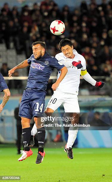 Clayton Lewis of Auckland City and Mitsuo Ogasawara of Kashima Antlers compete for the ball during the FIFA Club World Cup Play-off for Quarter Final...
