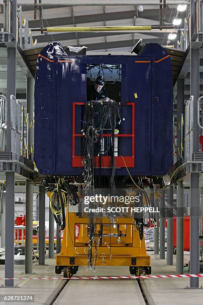 Employees work on the Hitachi Intercity Express Programme train production line at Hitachi's manufacturing plant in Newyton Aycliffe, north-east...