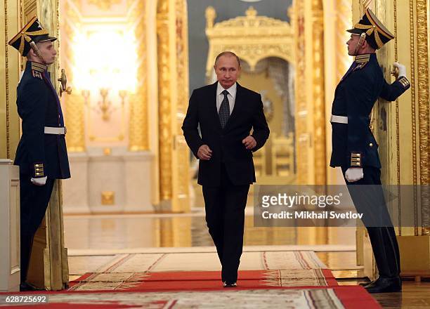 Russian President Vladimir Putin arrives to speak during a reception marking the Heroes of the Farherland's Day at the Grand Kremlin Palace on...