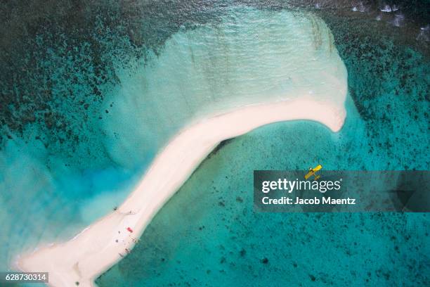 aerial view of a tropical sand bar with passing light aircraft. - clippers stock pictures, royalty-free photos & images