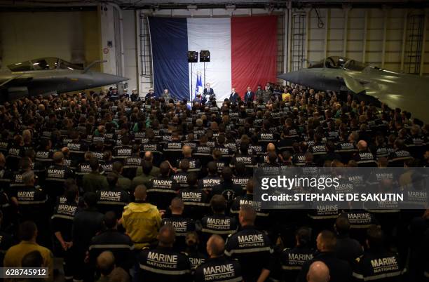 French President Francois Hollande delivers a speech during a visit on board the aircraft carrier Charles-de-Gaulle operating in the eastern...
