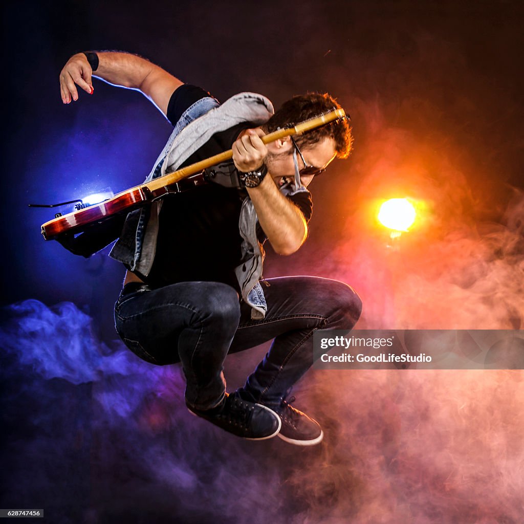 Guitarist jumping on stage