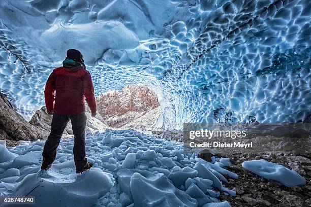 hiker with crampon looking out of  ice cave - berchtesgaden - berchtesgaden national park bildbanksfoton och bilder