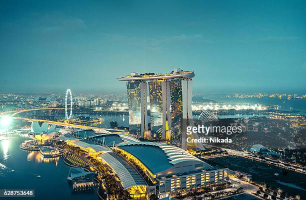 aerial view over singapore  with marina bay sands hotel, singapore - singapore stockfoto's en -beelden