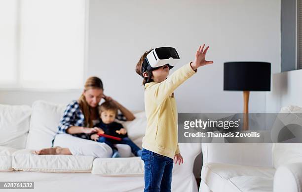 5 year old boy wearing virtual reality glasses - cardboard vr stock pictures, royalty-free photos & images