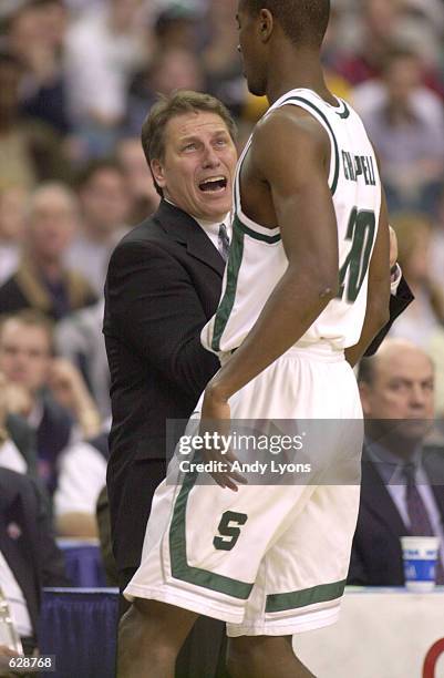 Zach Randolph of Michigan State gets an earful from coach Tom Izzo during their NCAA South Region Final game against Temple at the Georgia Dome in...