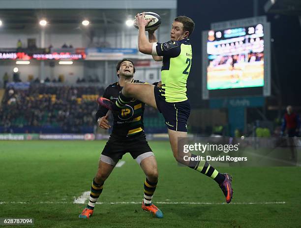 Rory O'Loughlin of Leinster beats Ben Foden to the high ball to score a try during the European Rugby Champions Cup match between Northampton Saints...