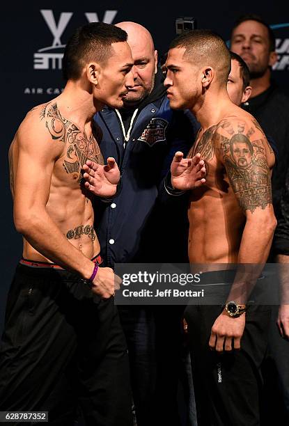 Opponents Max Holloway and Anthony Pettis face off during the UFC weigh-in at Air Canada Centre on December 9, 2016 in Toronto, Ontario, Canada.