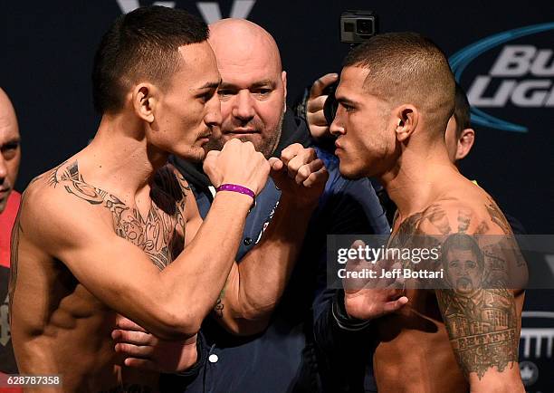 Opponents Max Holloway and Anthony Pettis face off during the UFC weigh-in at Air Canada Centre on December 9, 2016 in Toronto, Ontario, Canada.